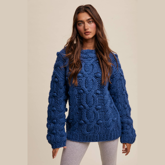 Woman wearing a blue knitted sweater on a beige background